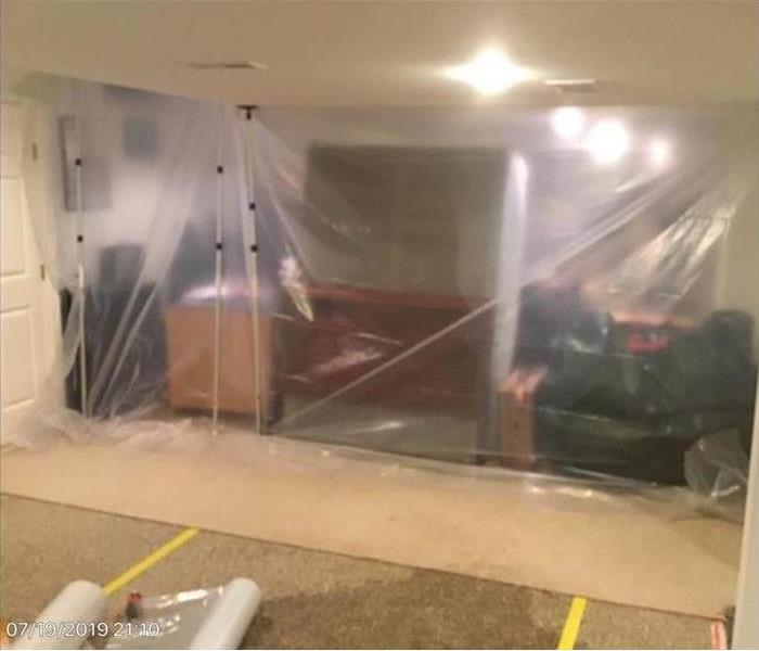room protected from further damage by plastic wall barrier