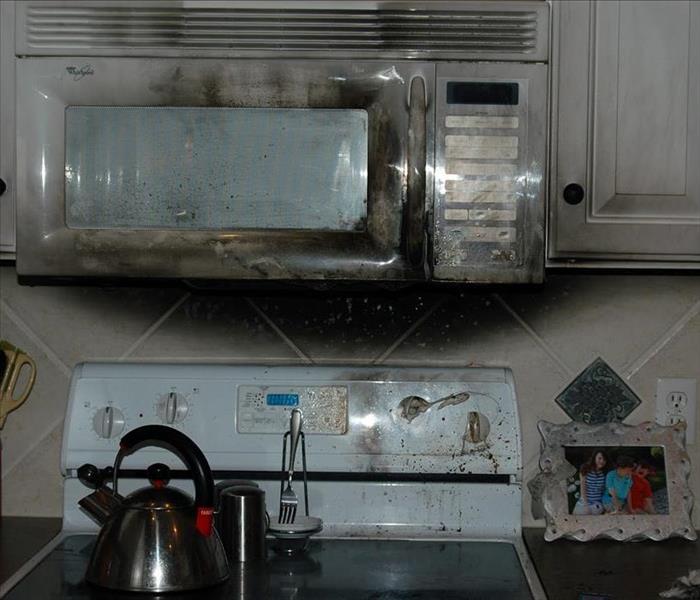 Kitchen appliances covered in smoke damage
